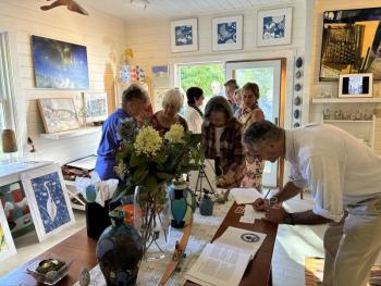 Bidders signing up for bid numbers prior to  the auction to benefit the CRC (Community Resource Council).  LISA KRISTOFF/Boothbay Register