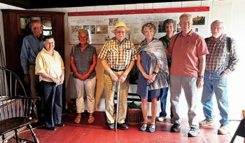 Chapman-Hall House Committee members and volunteers honor the work of David Griffin, who designed the timeline display. Pictured from left: William Brewer, Louise Miller, Deane Brewer, Calvin Dodge, Kathy Moran, Patti Whitten, David Griffin, and Jeff Miller. Elizabeth Potter photo