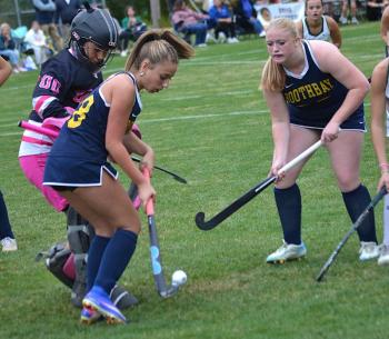 With Winthrop goalie Cyara Harriman nearby, freshman Emma Doucette (#28) and sophomore Lilly Cowing look to gain control of the ball in front of the goal in the first half. KEVIN BURNHAM/Boothbay Register