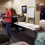 Speaking at the Community Center, Aug. 14, Merritt Blakeslee (standing, left) and Larry Brown (standing, right) ask for volunteers to scan historic Boothbay Register issues. JANE CARPENTER/Boothbay Register 