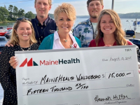 Hilton Family and Cindy Wade, President of LincolnHealth hold a 15,000 check, a donation from the Hilton Family in honor of Brenda Hilton
