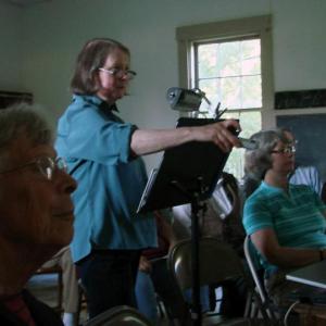 Doreen Conboy of Alna changes a slide in her July 27 talk on the life of Joe Jones, a local scow captain in the late 1800s and early 1900s. SUSAN JOHNS/Wiscasset Newspaper