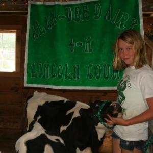 Nichole Jewett, president of Alan Dee Dairy 4H in Lincoln County, stood in the barn at Morris Farm with cows Ashlyn and Ravyn and welcomed guests of the farm during Open Farm Day, held on July 22. JOHN MAGUIRE/Wiscasset Newspaper Nichole Jewett, president of Alan Dee Dairy 4H in Lincoln County