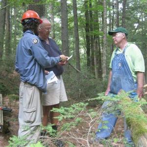 Maine Conservation Corps member works with Lincoln County Historical Association volunteers George Keyes and Ed Kavanagh on a new trail system in Dresden.