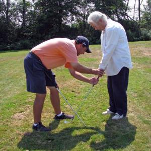 Golf instructor Johnny Johnston assists Lee Rushmore during a Spectrum Generations golf workshop at Wawanock County Club. Courtesy of Spectrum Generations