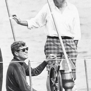 Kennedy enjoys a sail aboard the 62’ Coast Guard training yawl The Manitou. Standing, right, and chosen to take Kennedy's Senate seat vacated for the presidency is his Harvard roommate Ben Smith of Massachusetts. Courtesy of Tom Carbone Archives