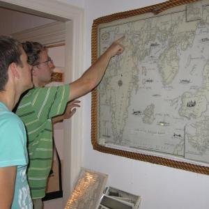 Lupieka, foreground, and Joshua Edwards look at a historic map of the Boothbay region at the Balmy Days Museum.