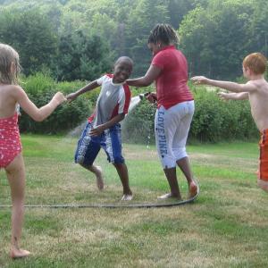Tyrese, 10, from the Bronx, N.Y., second from left, and Reanna, 12, from Brooklyn, N.Y., third from left, have fun with a water hose during their visit with the Eve and Robert Conlin family in Boothbay. Tyrese, 10, from the Bronx, N.Y., second from left, and Reanna, 12, from Brooklyn, N.Y., third from left, have fun with a water hose during their visit with the Eve and Robert Conlin family in Boothbay.