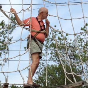 Edgecomb summer resident Don Fry gears up for his zipline descent.