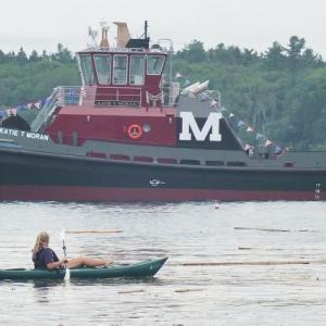 A kayaker joins the many other boats out into the harbor watching the tugboat launch. JOHN MAGUIRE/Boothbay Register Katie T. Moran, Washburn and Doughty, Boothbay, east Boothbay, tugboat