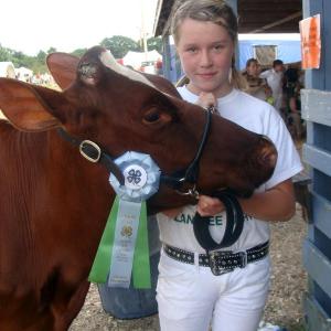 Nicole Jewett of Wiscasset and 15-month old Rosie, a Holstein heifer, celebrate their win in the Jr. Holstein division of the Open Show at the Union Fair. 