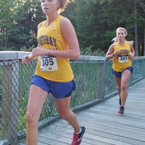 Hannah Morley and Morgan Crocker cross the bridge at Penny Lake. Morley and Crocker finished second and fifth place respectively at the first home meet of the season. Below, Brady Duncan and David Machon sprint toward the finish line. The boys team earned third place out of five MVC teams at the September 12 meet hosted by Boothbay Region High School. RYAN LEIGHTON/Boothbay Register Hannah Morley and Morgan Crocker cross the bridge at Penny Lake. Morley and Crocker finished second and fifth place respectively at the first home meet of the season. RYAN LEIGHTON/Boothbay Register