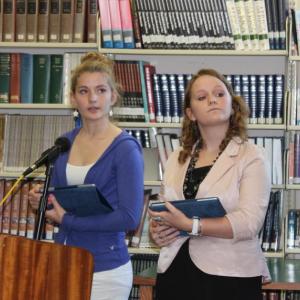 Sophomore Maya Schwehm, left, and junior Courteney Chaney represent The Heritage Foundation in this year’s debate.  Here the students give their opening remarks, bolstered by an iPad chock full of data.