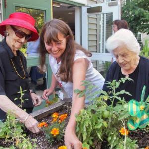 Marie Callnan (on left), Gregory Wing Activities Director Jerie Phinney, and Veula Reed (on right) work in one of the raised bed gardens outside the Gregory Wing at St. Andrews Village. A new garden made possible by the St. Andrews Hospital Auxiliary will make it easier for more residents to enjoy the outdoors in an unstructured but secure atmosphere. The new garden features a walkway, patio and wooden fence. Courtesy of Lincoln County Healthcare Marie Callnan (on left), Gregory Wing Activities Director Jerie Phinney, and Veula Reed (on right) work in one of the raised bed gardens outside the Gregory Wing at St. Andrews Village. A new garden made possible by the St. Andrews Hospital Auxiliary will make it easier for more residents to enjoy the outdoors in an unstructured but secure atmosphere. The new garden features a walkway, patio and wooden fence. Courtesy of Lincoln County Healthcare