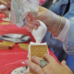De Amplo constructs a gingerbread house. BEN BULKELEY/Boothbay Register