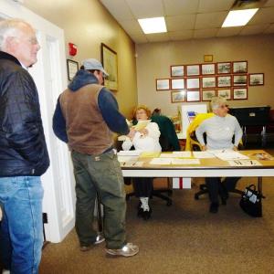 Volunteers hand out ballots.