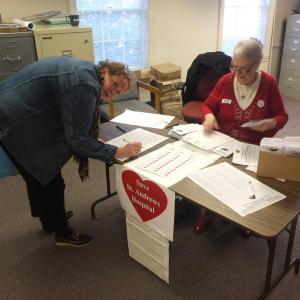 Kerri Kelley signs the St. Andrews petition after voting at the Boothbay Town Office. As of 12:45 p.m., over 771 signatures from four towns have been collected.  