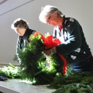 Valerie Betts works at the wreath table November 14 during a Boothbay Region Garden Club event at the Southport Town Hall. Below: Jane Lunt, left, and Penny Thumith work together to construct cocoa cones, and De Amplo constructs a gingerbread house. BEN BULKELEY/Boothbay Register Valerie Betts works at the wreath table November 14 during a Boothbay Region Garden Club event at the Southport Town Hall. BEN BULKELEY/Boothbay Register