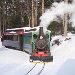 The train chugs through the snow toward Santa’s Station. Courtesy of the Boothbay Railway Village 