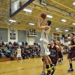 Evan Hepburn slices through two Monmouth defenders. BEN BULKELEY/Boothbay Register