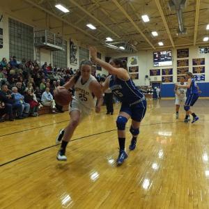 Captain Alex Clarke drives hard to the basket, trying to outrun her Madison defender.  RYAN LEIGHTON/ Boothbay Register 