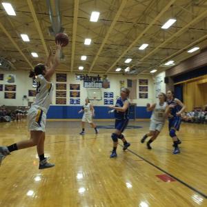 Abby McLellan grabs a high flying pass as Sarah Caron cuts down the middle.  RYAN LEIGHTON/ Boothbay Register 