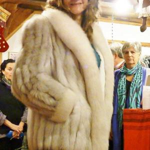 Mary Batakis shows off a fox fur coat retailing at $1,200, on sale at A Second Season for $500. KATRINA CLARK/Boothbay Register