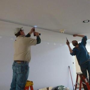 Ron Arsenault, left, and Ted Dowling work to remove the track lighting in Eventide’s expansion. KATRINA CLARK/Boothbay Register