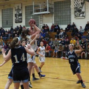 Alex Clarke dodges the Dirigo defense with a spin-around shot in the lane. Below: Abby McLellan gets the rebound and a quick put-back before Dirigo can react. RYAN LEIGHTON/Boothbay Register Alex Clarke dodges the Dirigo defense with a spin-around shot in the lane.