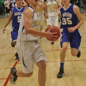 Andrew Hallinan drives to the basket on a fast break for two of his 13 points. KEVIN BURNHAM/Boothbay Register
