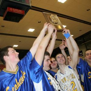 Team captains Linc Simmons and Anthony DiMauro hold up the championship plaque while surrounded by teammates. KEVIN BURNHAM/Boothbay Register
