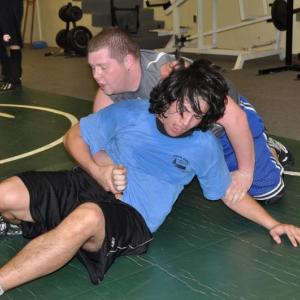 Boothbay Region High School's Antonio Maulolo, front, tries to get out of a hold during a February 11 wrestling practice at Lincoln Academy. Below: Howard Carter, left, puts Coach Don Waltz into a hold. BEN BULKELEY/Boothbay Register Boothbay Region High School's Antonio Maulolo, front, tries to get out of a hold during a February 11 wrestling practice at Lincoln Academy. BEN BULKELEY/Boothbay Register