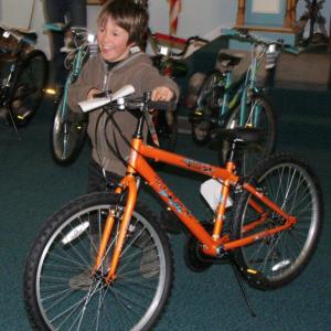 Charlie Moss shows his pleasure in earning one of the 21 bicycles from area Masons through the summer reading program offered at the Boothbay Harbor Memorial Library. KEVIN BURNHAM/Boothbay Register
