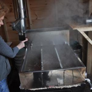 Finch checks boiling sap March 25 at Hidden Treasure Farm in Jefferson. BEN BULKELEY/Boothbay Register