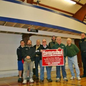 Standing below the YMCA's new scorer's roost are some of the instrumental people in getting the new feature built. From left are, front row: Scott Bennett, Harold Buzzell and Tom Nickerson of Hammond Lumber, Neal Verge; back row: Eddie Crocker, Bill Haney, Jonn Trees and Bob Hasch. KEVIN BURNHAM/Boothbay Register Standing below the YMCA's new scorer's roost are some of the instrumental people in getting the new feature built. From left are, front row: Scott Bennett, Harold Buzzell and Tom Nickerson of Hammond Lumber, Neal Verge; back row: Eddie Crocker, Bill Haney, Jonn Trees and Bob Hasch. KEVIN BURNHAM/Boothbay Register
