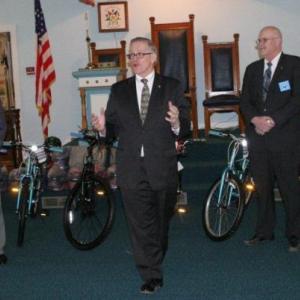 Before giving away 21 new bicycles,Tom Pulkkinen of Bay View Lodge, second from left, explains to parents, grandparents and children about the Bikes for Books program and how it came to be implemented locally during the presentation at the Masonic Hall in East Boothbay on Saturday, March 16. Standing behind Pulkkinen are local Masons, from left, Arthur Richardson, Kim Pinkham and Micheal Leighton. Below: Charlie Moss shows his pleasure in earning one of the 21 bicycles from area Masons through the summer reading program offered at the Boothbay Harbor Memorial Library. KEVIN BURNHAM/Boothbay Register Before giving away 21 new bicycles,Tom Pulkkinen of Bay View Lodge, second from left, explains to parents, grandparents and children about the Bikes for Books program and how it came to be implemented locally during the presentation at the Masonic Hall in East Boothbay on Saturday, March 16. Standing behind Pulkkinen are local Masons, from left, Arthur Richardson, Kim Pinkham and Micheal Leighton.