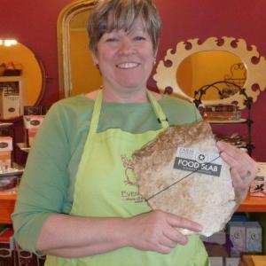 Owner Denise Demeter holds a Food Slab board, one of the many new products being sold at Eventide Artisan Bread & Cheese. KATRINA CLARK/Boothbay Register