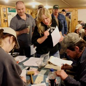 Sophia Stark, with membership papers in hand, waits to be officially signed in as a member by Treasurer Keith Royal. Stark was one of ten new members who joined the association during Wednesday’s celebration.  SUE MELLO/Boothbay Register