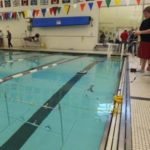 Eli Farnham maneuvers his robot at the YMCA pool in Bath, while his partner Linc Simmons looks on. RYAN LEIGHTON/Boothbay Register