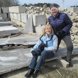 Jennifer Litchfield, left, and Donna Dennison of Boothbay Region Arts Foundation try out Jim Taliana's future memory bench at J.C. Stone rock quarry. Courtesy of Barbara Eldred