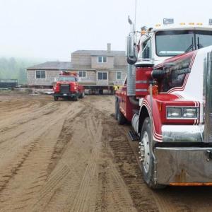 Two wrecker trucks  trucks get ready to haul the country club house up to the hill on May 29. RYAN LEIGHTON/Boothbay Register