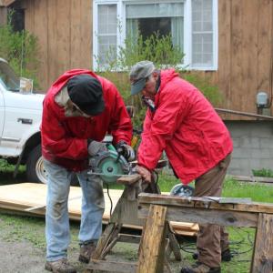 Seth Hedgcock, left, and Tony Curulla cut boards for siding repair at a house on King Phillips Trail. SUE MELLO/Boothbay Register