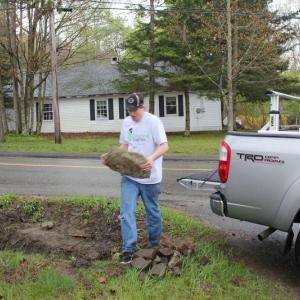 Ben Dewey unloads rocks at Boothbay Green. SUE MELLO/Boothbay Register