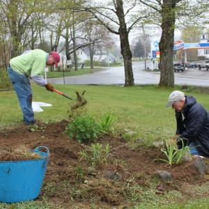 Russ Hoffman, left, and Bob Dent cleaning out the front garden at Boothbay Green.