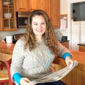Abby Gordon at her Boothbay Harbor condo, catching up on local news in the Boothbay Register. LISA KRISTOFF/Boothbay Register