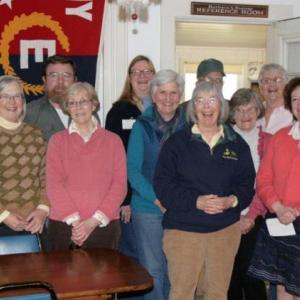 Barbara Rumsey, front (dark jersey), is surrounded by Historical Society volunteers during the gathering to honor her on April 25. Courtesy of Betsy Spekke