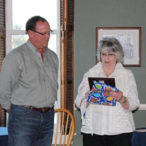 Barbara Wilson receives a plaque commemorating her 25 years of service to the town of Boothbay Harbor from Town Manager Tom Woodin. Courtesy of Trish Fallon 