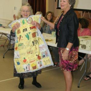 Ramona Gaudette holds the quilt presented to her by school guidance counselor Mrs. Buchan. KEVIN BURNHAM/Boothbay Register