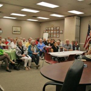 Perkins touts his new book, “Finding Moosewood, Finding God,” on June 14 at the Boothbay Harbor Town Hall. Program Director Barb House said the event had to be moved from the library to a bigger venue to accommodate those interested in attending the event. NICOLE LYONS/Boothbay Register