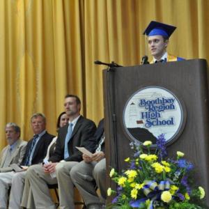 Evan Stevens delivers the Honor Essay as school representatives listen. BEN BULKELEY/Boothbay Register